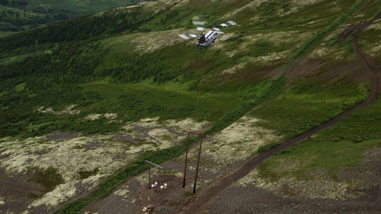 CH-47D Chinook Helicopter heavy lift mission lifting power line on construction site