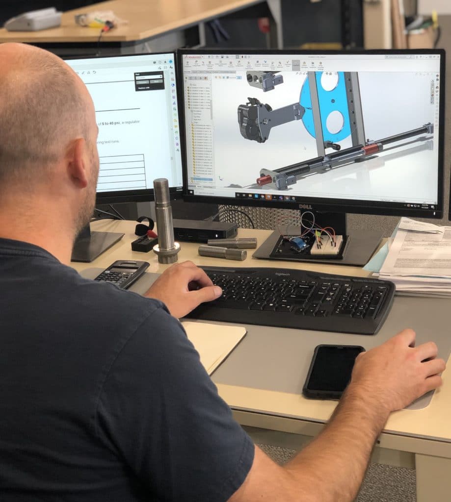 Engineering team working on CH-47D schematics